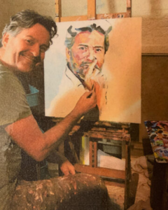 headshot of Paul Arts painting his own self portrait